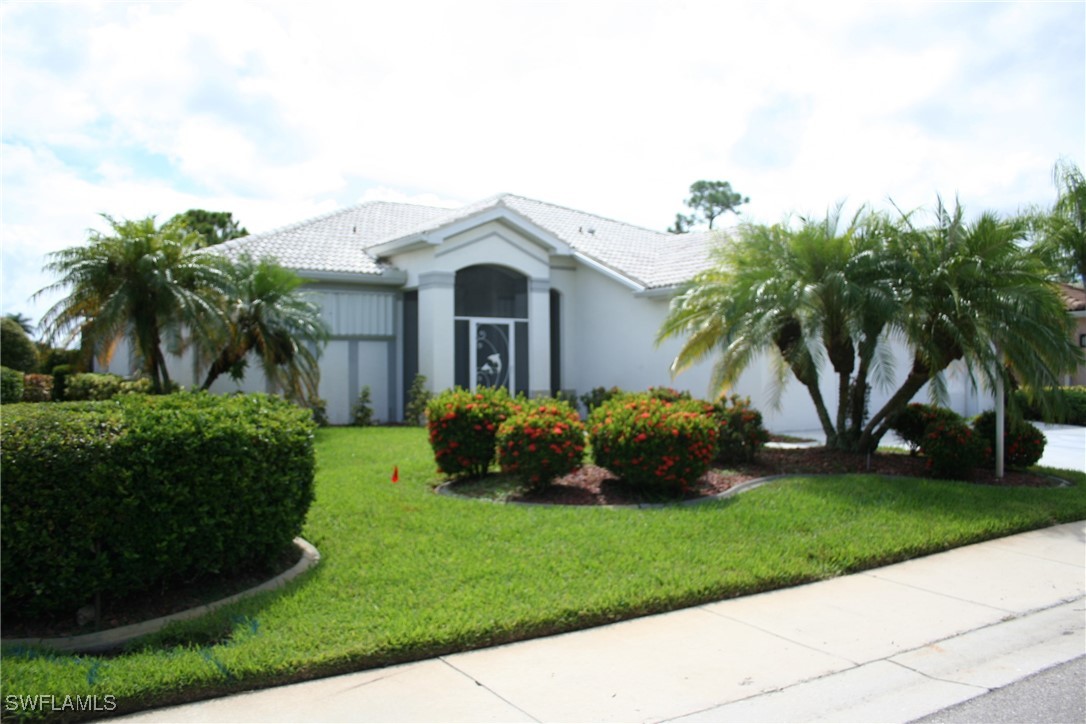 a front view of a house with a garden and plants