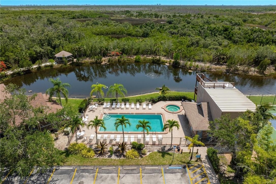 an aerial view of residential houses with outdoor space and lake view