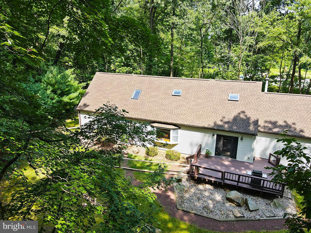 an aerial view of a house with garden space and sitting area