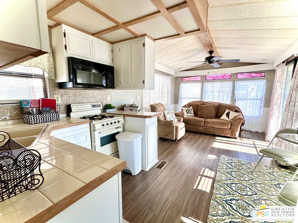 a living room with furniture and flat screen tv