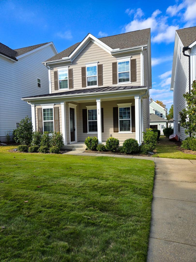 a front view of a house with a yard