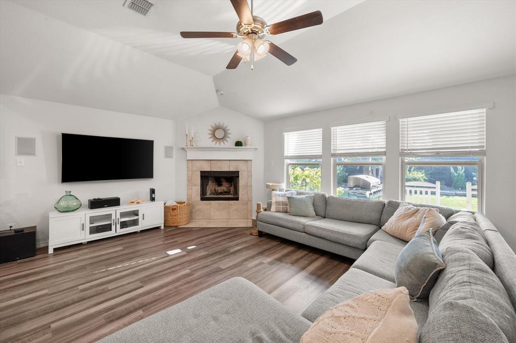 a living room with furniture a flat screen tv and a fireplace