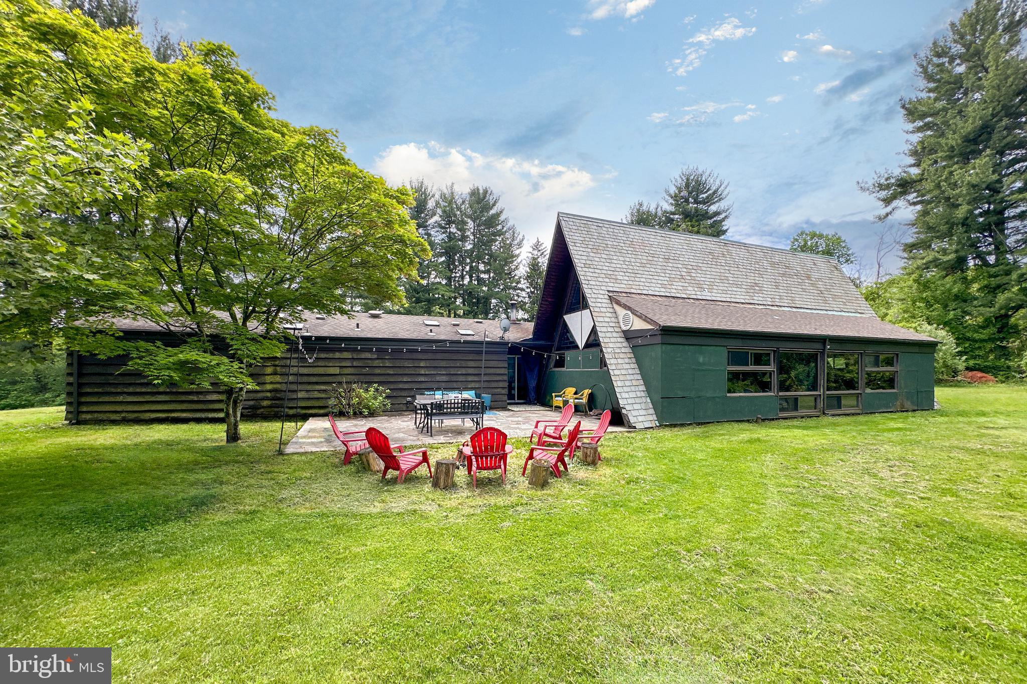 a backyard of a house with table and chairs