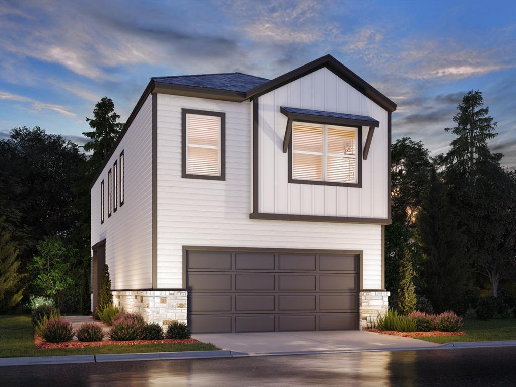 a front view of a house with garage