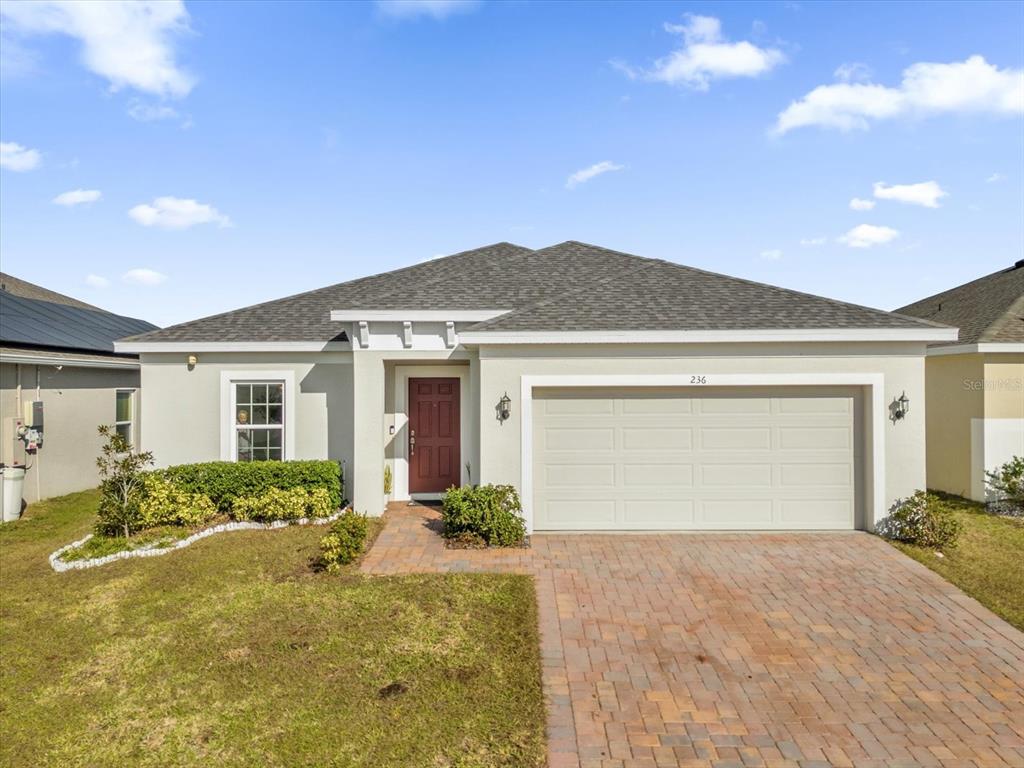 a front view of a house with a yard and garage