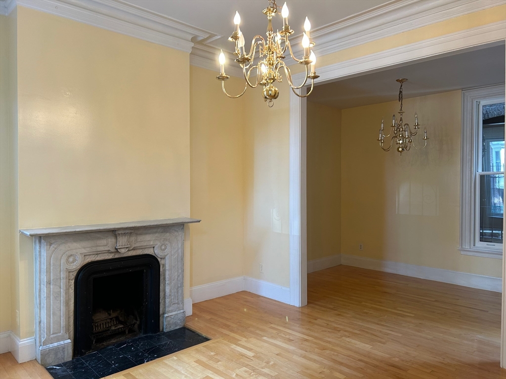 a view of a livingroom with a fireplace and chandelier