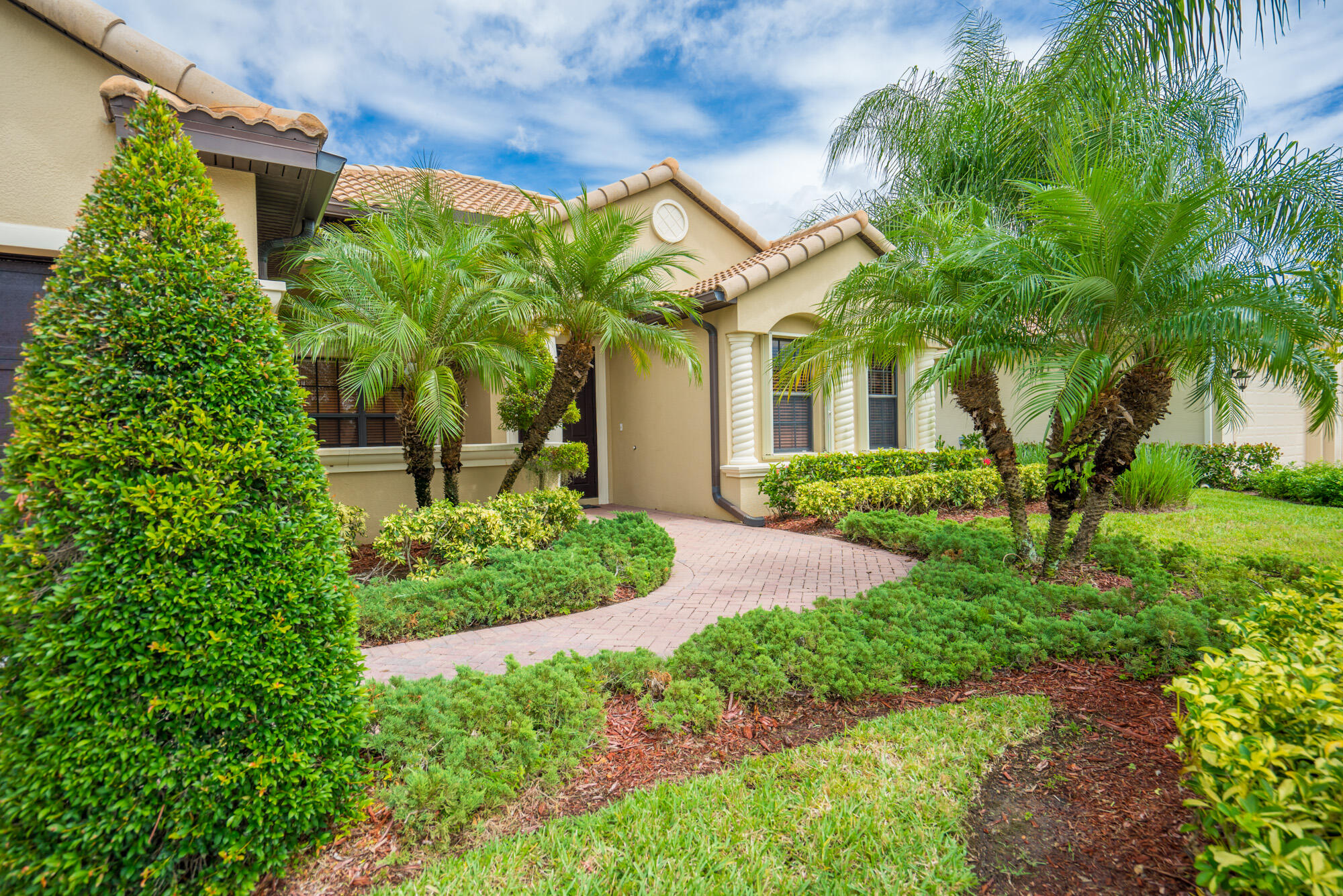 a front view of a house with garden