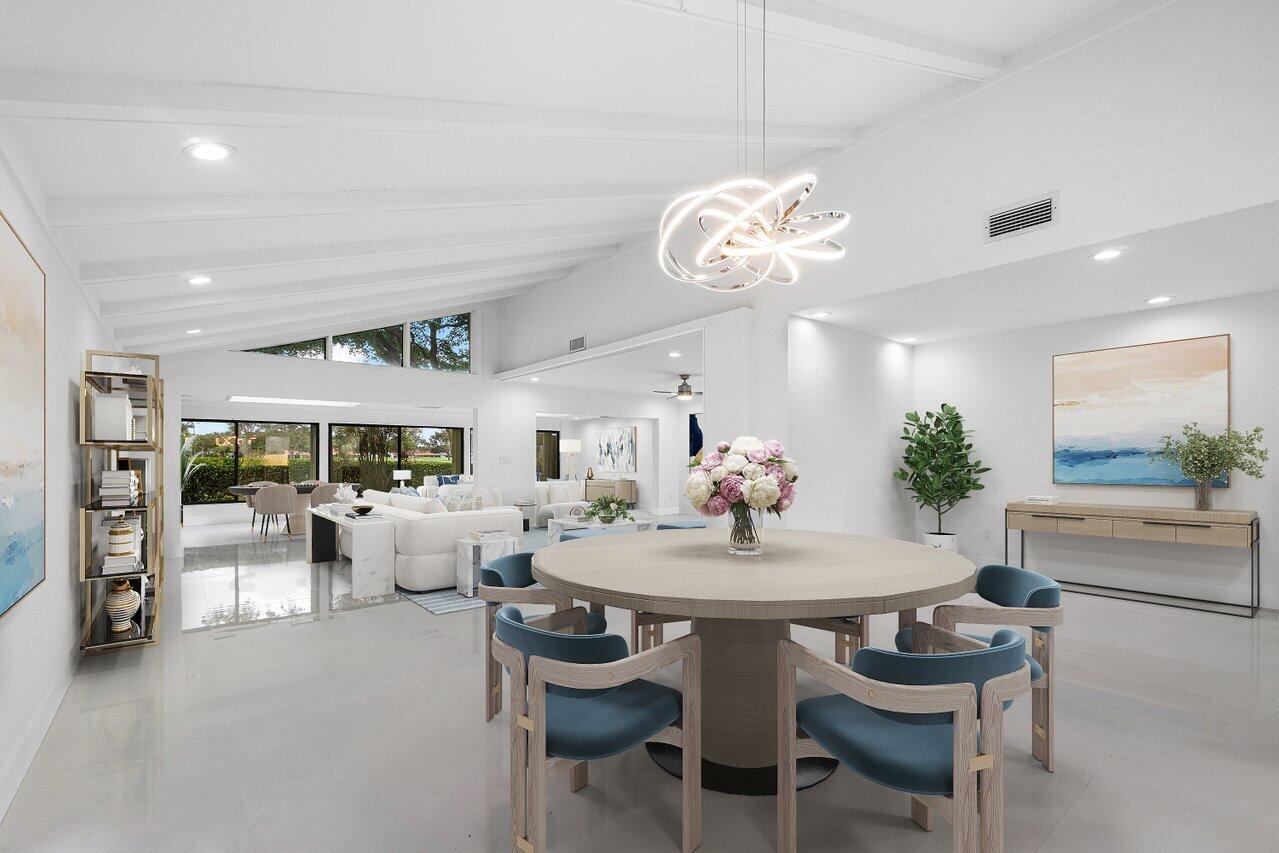 a view of a dining room with furniture and a chandelier