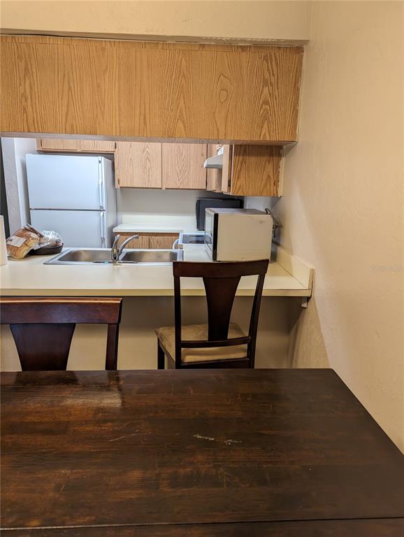 a view of kitchen with cabinets and window