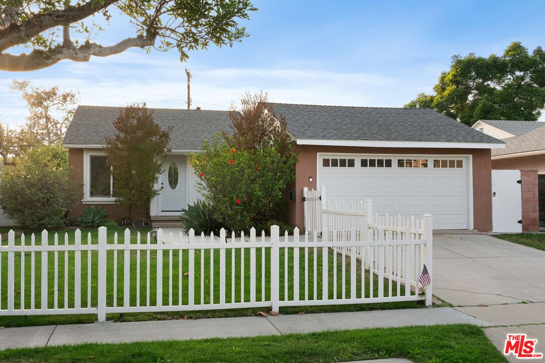 a view of a house with a small yard and plants