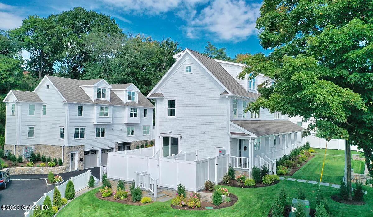 a aerial view of a house with yard and green space