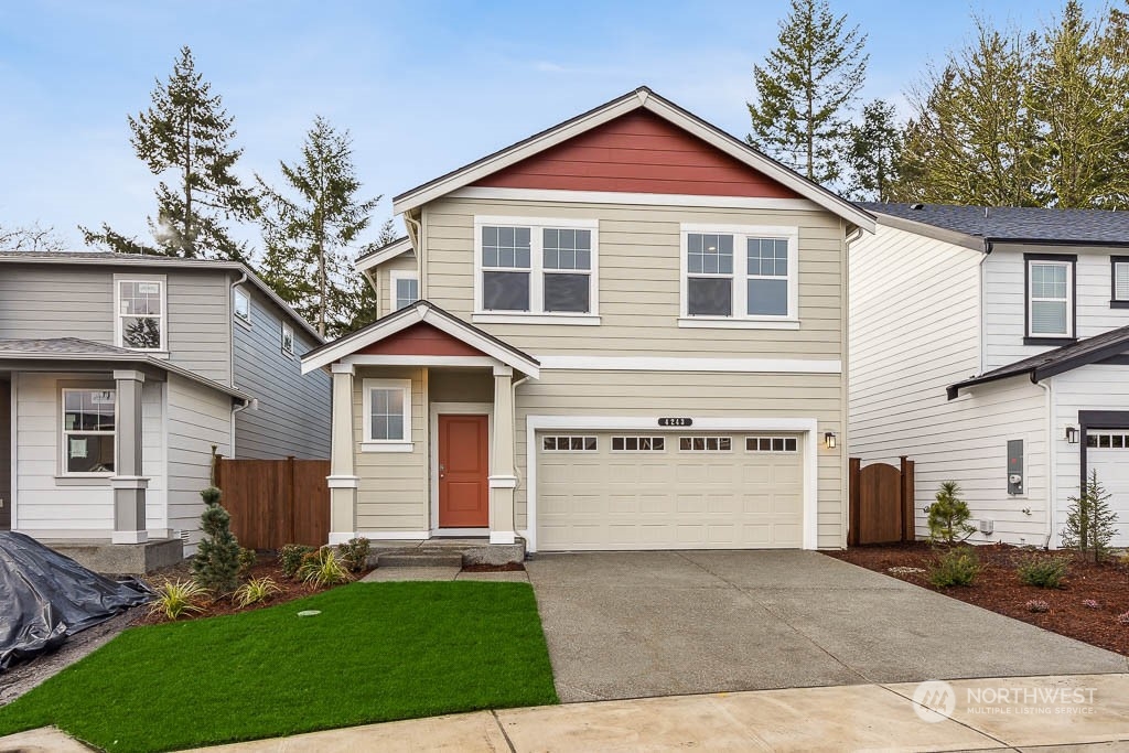 a front view of a house with a yard and garage