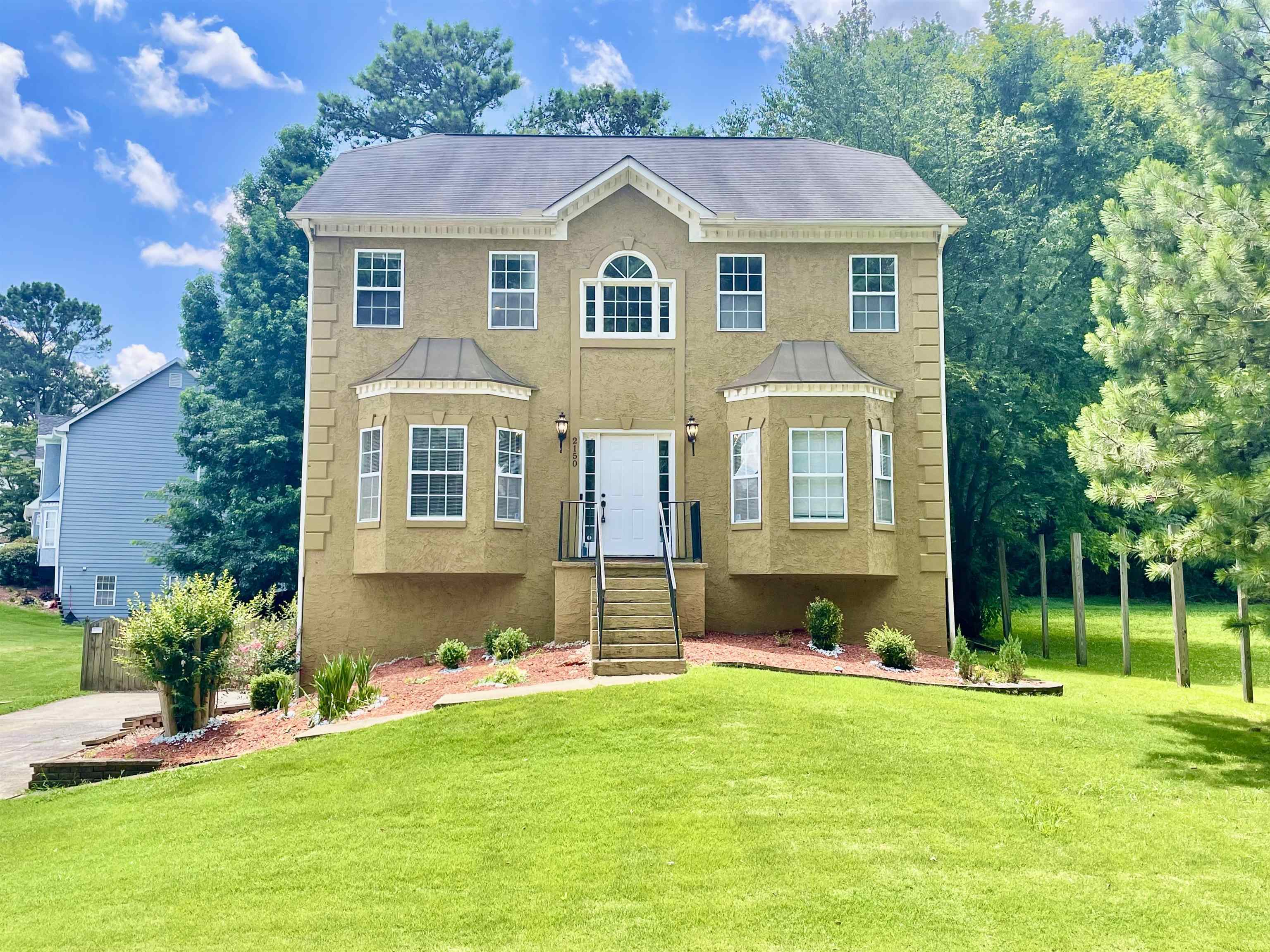 a front view of a house with a yard