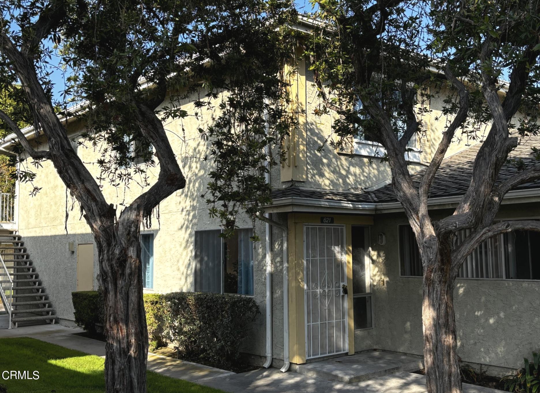 a view of a house with a tree