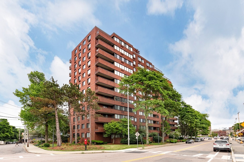 a view of a tall building next to a road