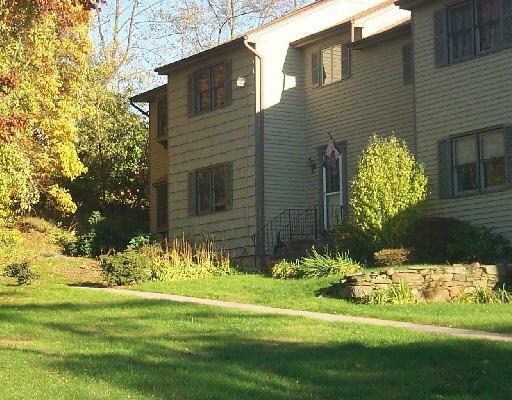 a front view of a house having a yard