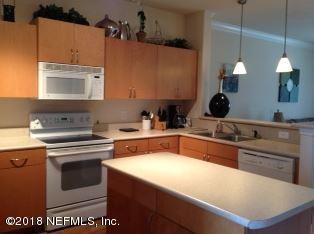 a kitchen with a stove a sink and a microwave