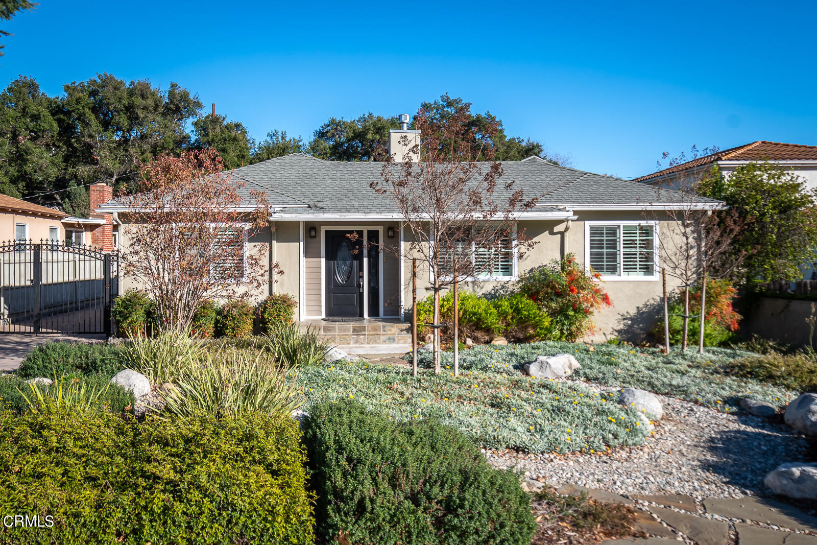 a front view of a house with a garden