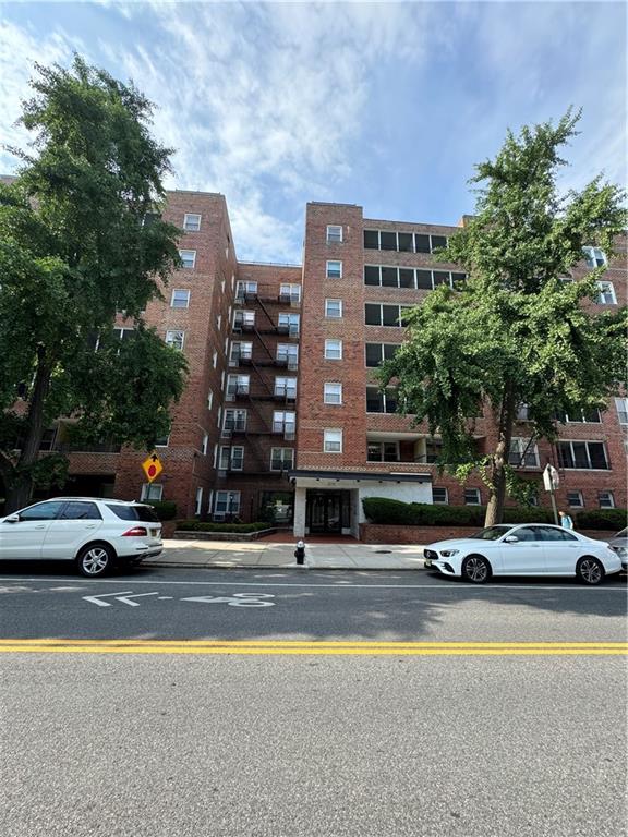 a building with car parked in front of it