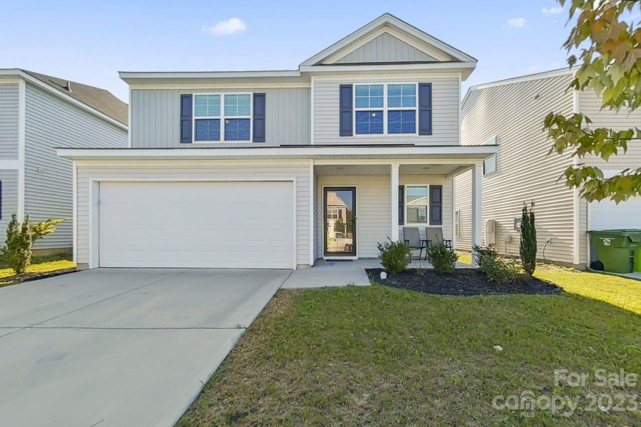 a front view of a house with a yard and garage