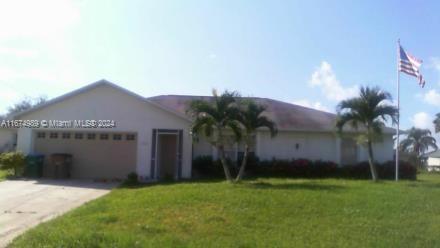 a view of a house with a yard and a garage