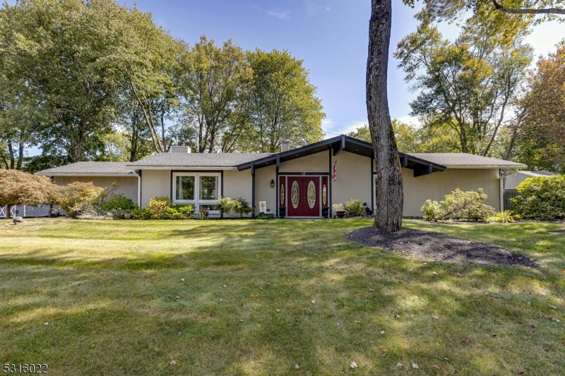 a view of a house with a yard and tree s