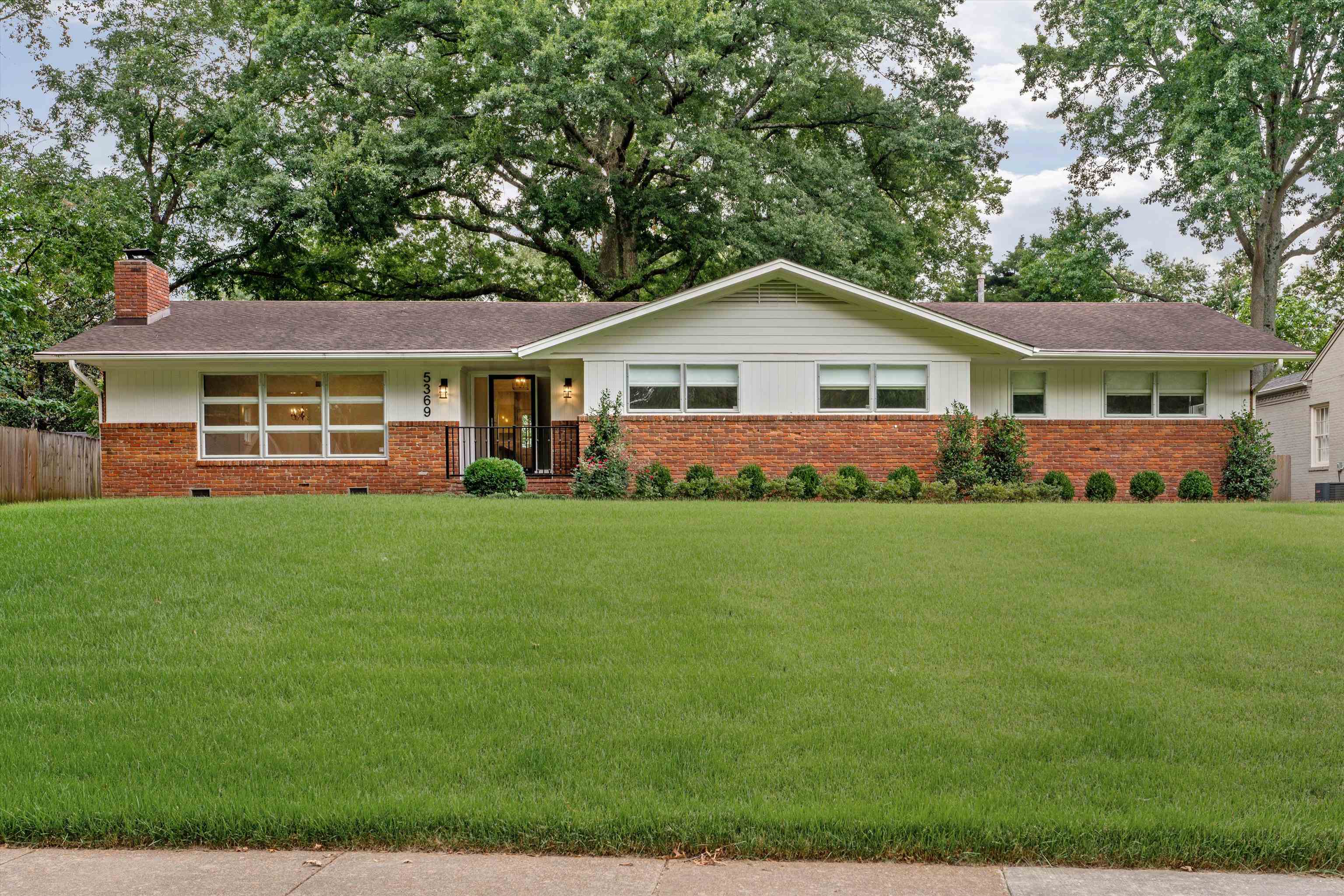 a front view of a house with a garden