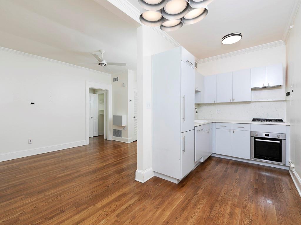 a view of a kitchen with wooden floor and a sink