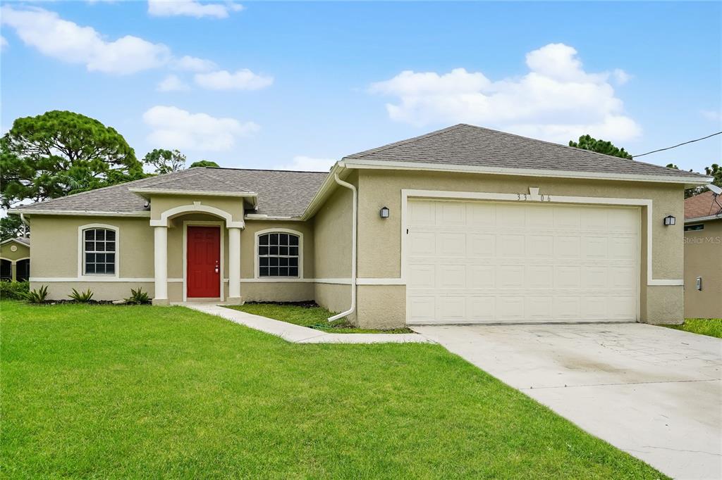 a front view of a house with a garden and yard