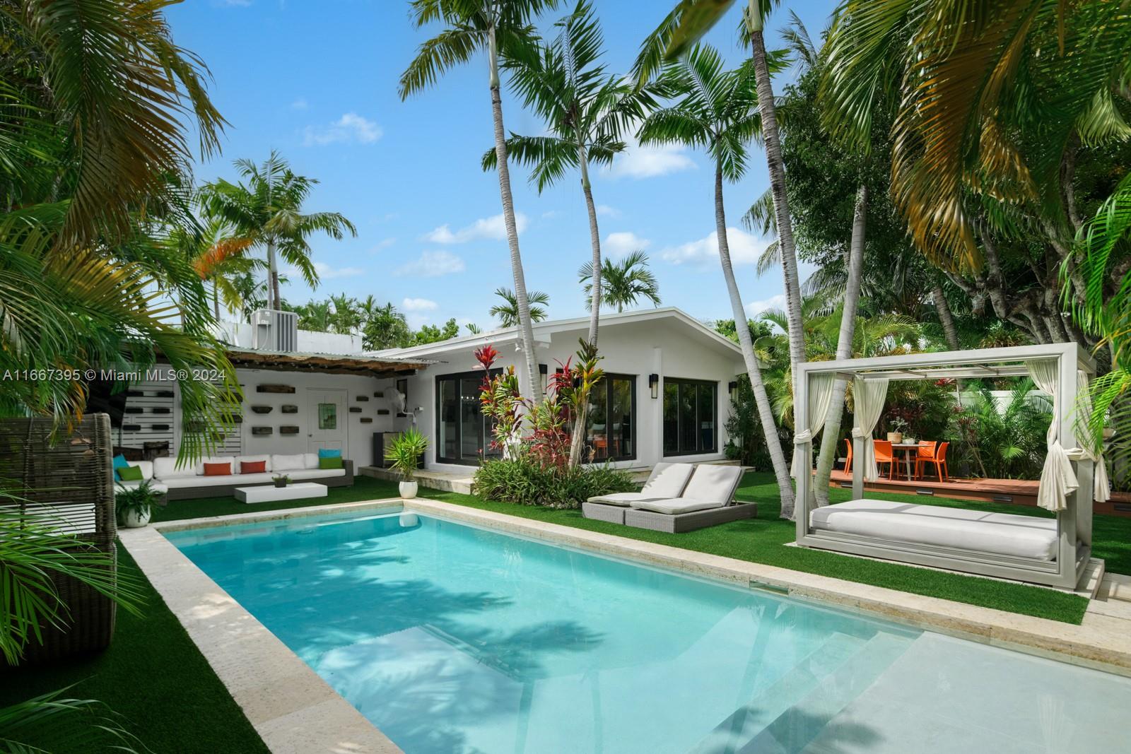 a view of a house with backyard porch and sitting area