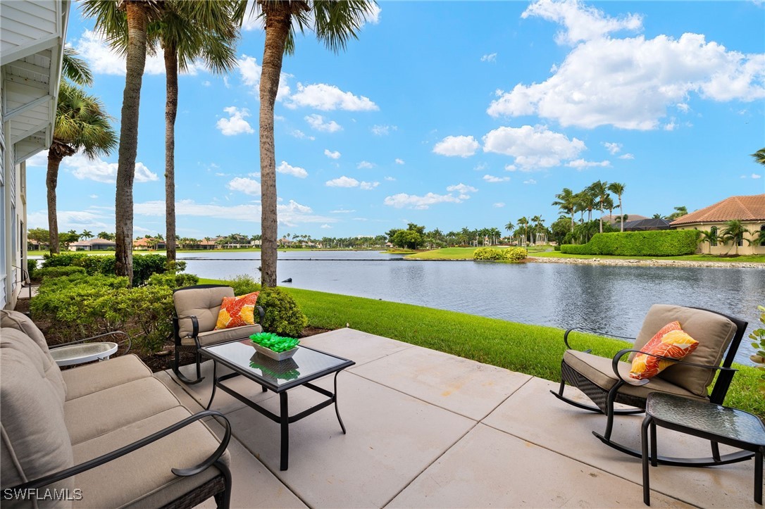 a view of a lake with table and chairs