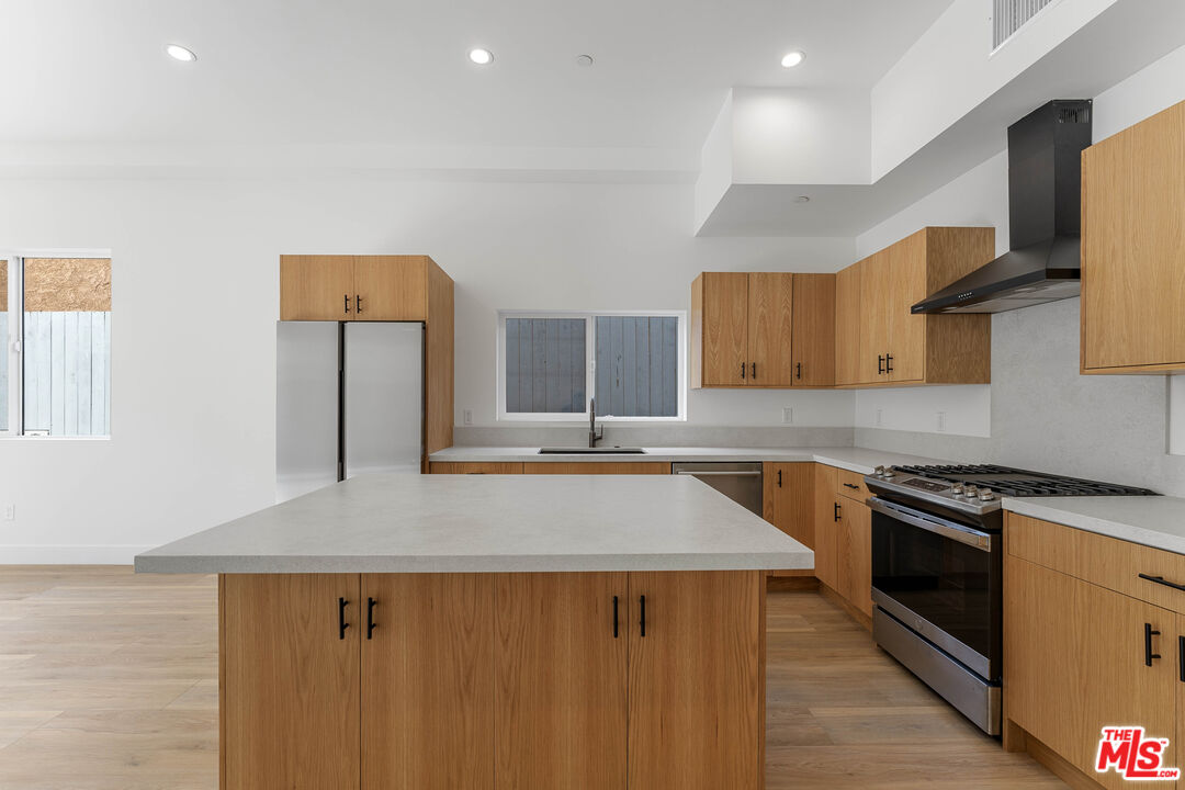 a kitchen with stainless steel appliances a sink stove and cabinets