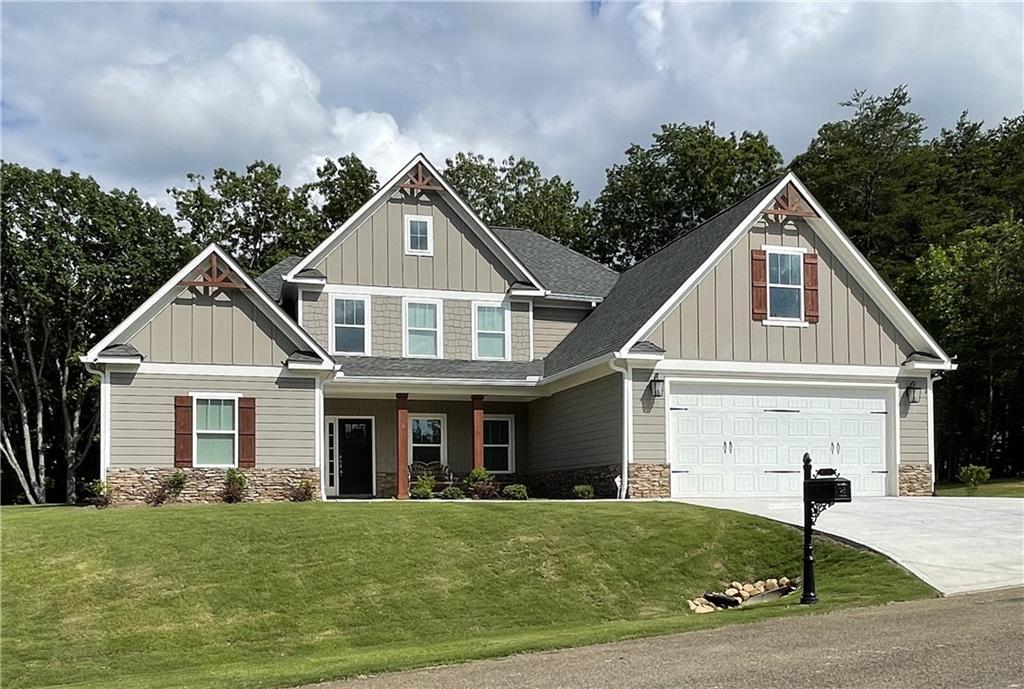 a front view of a house with a yard and garage