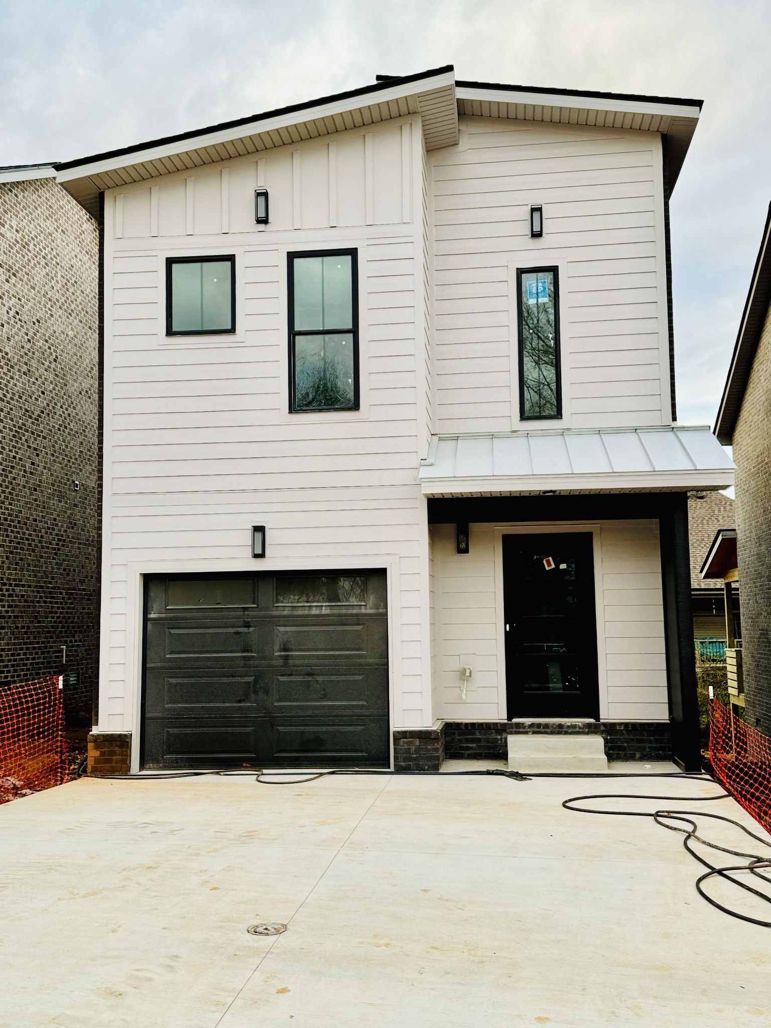 a front view of a house with a road