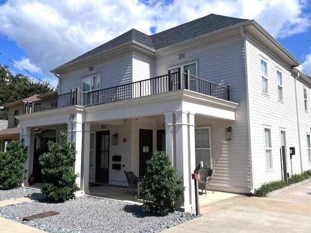 Back of house featuring a balcony