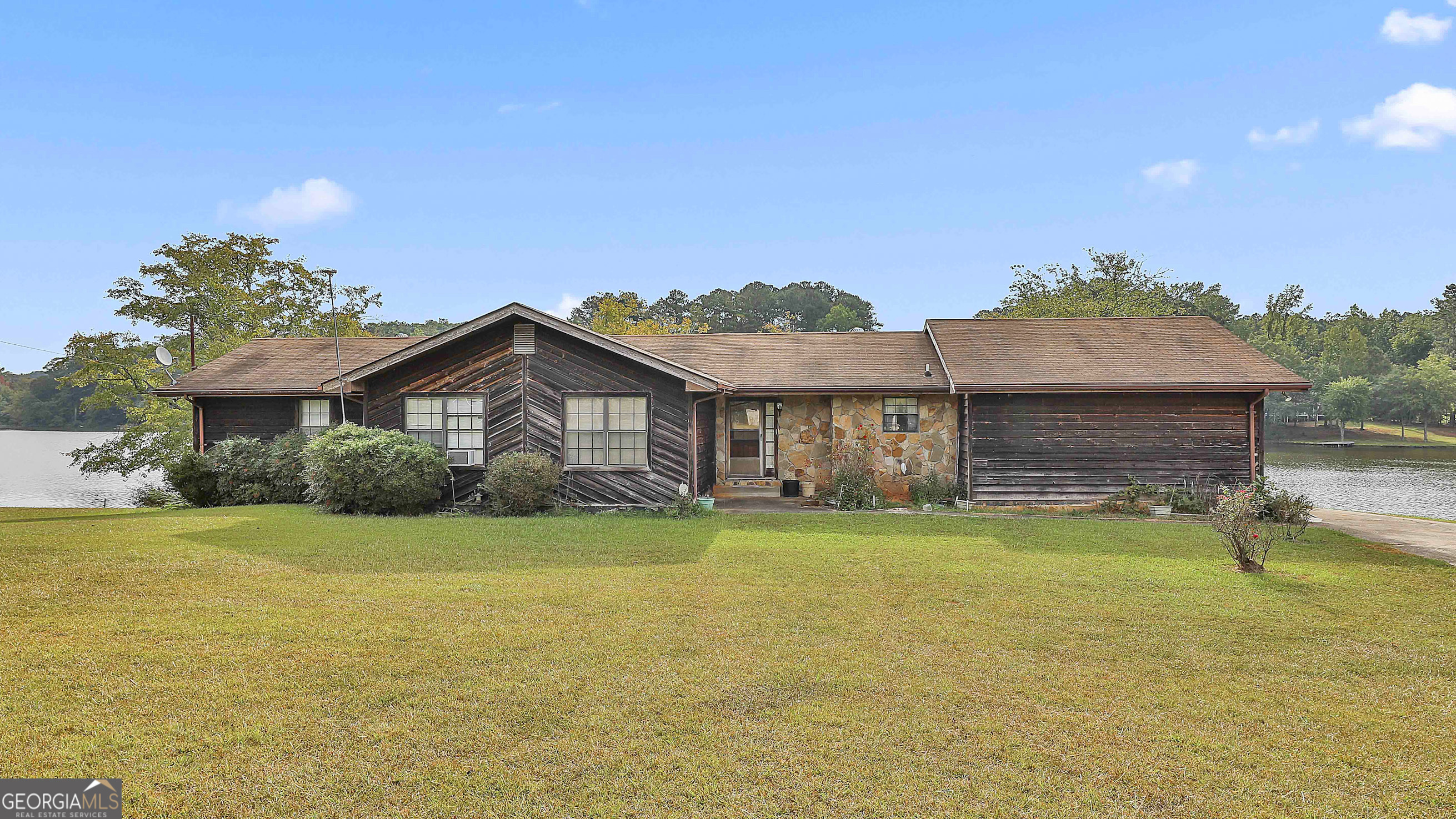 a front view of a house with a garden and porch