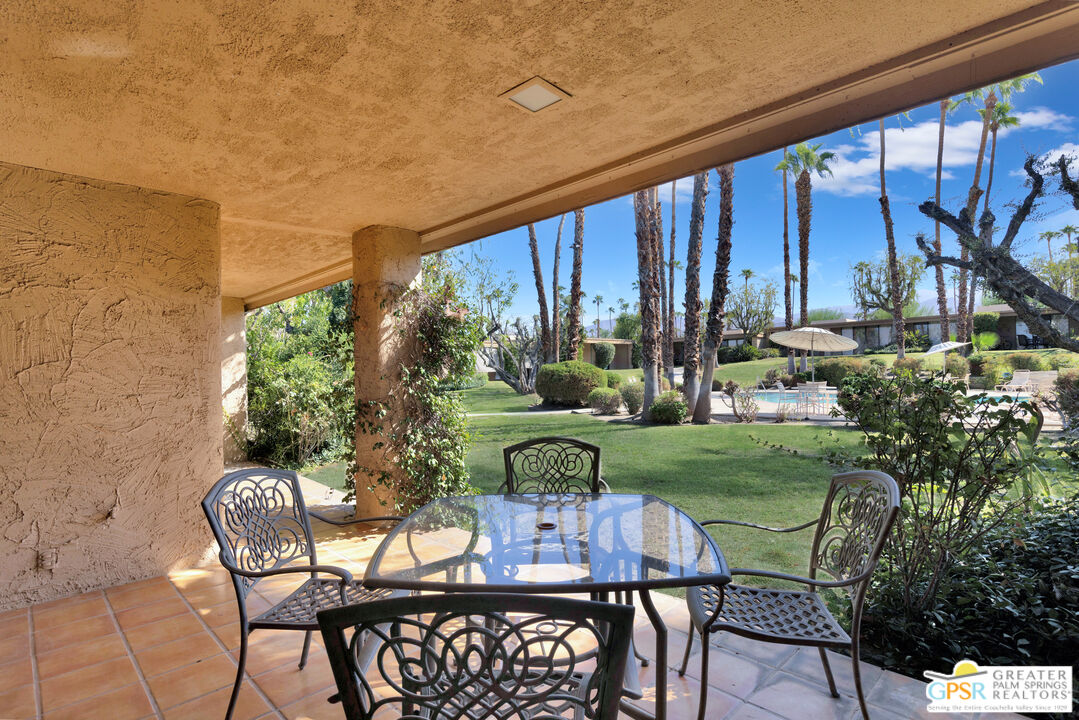 a view of a chairs and table in patio