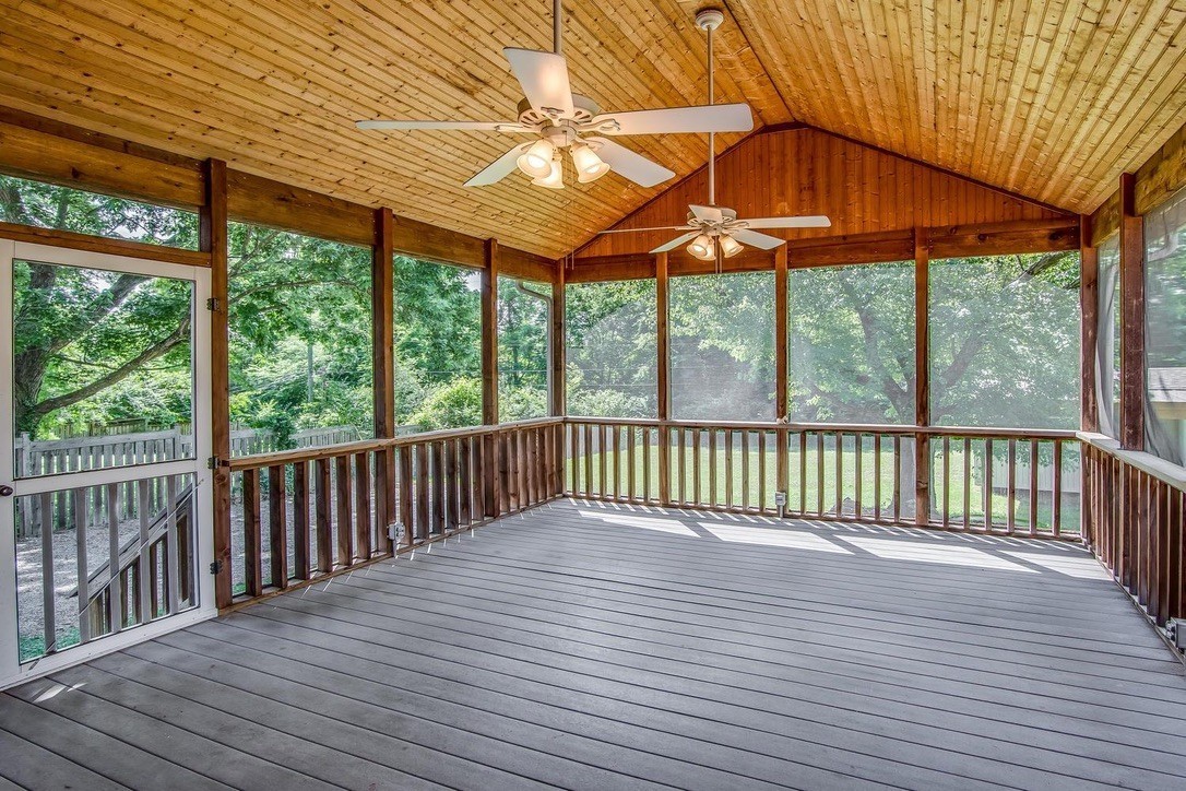 a view of a wooden deck with a yard