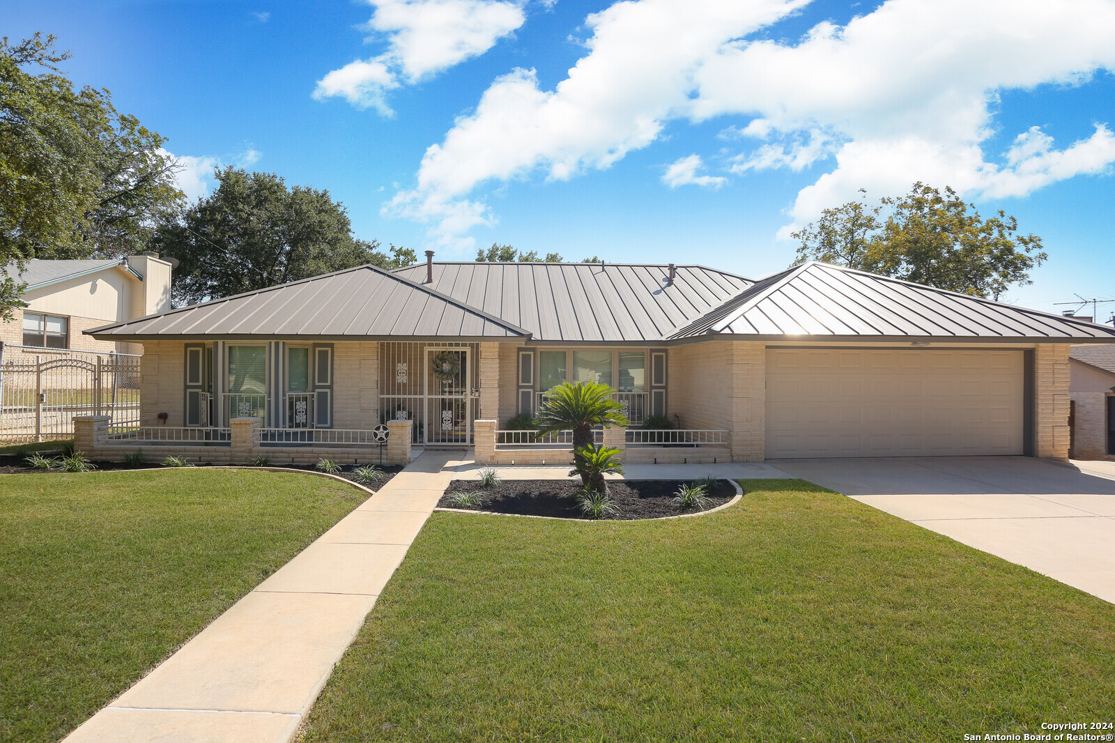 a front view of a house with a garden and patio