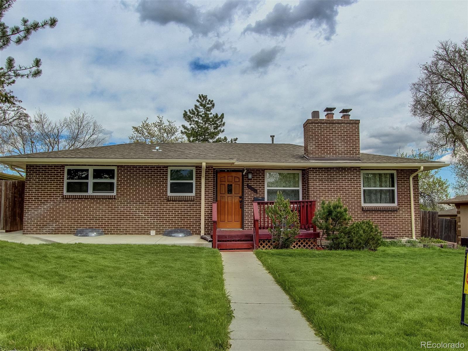 a front view of house with yard and green space