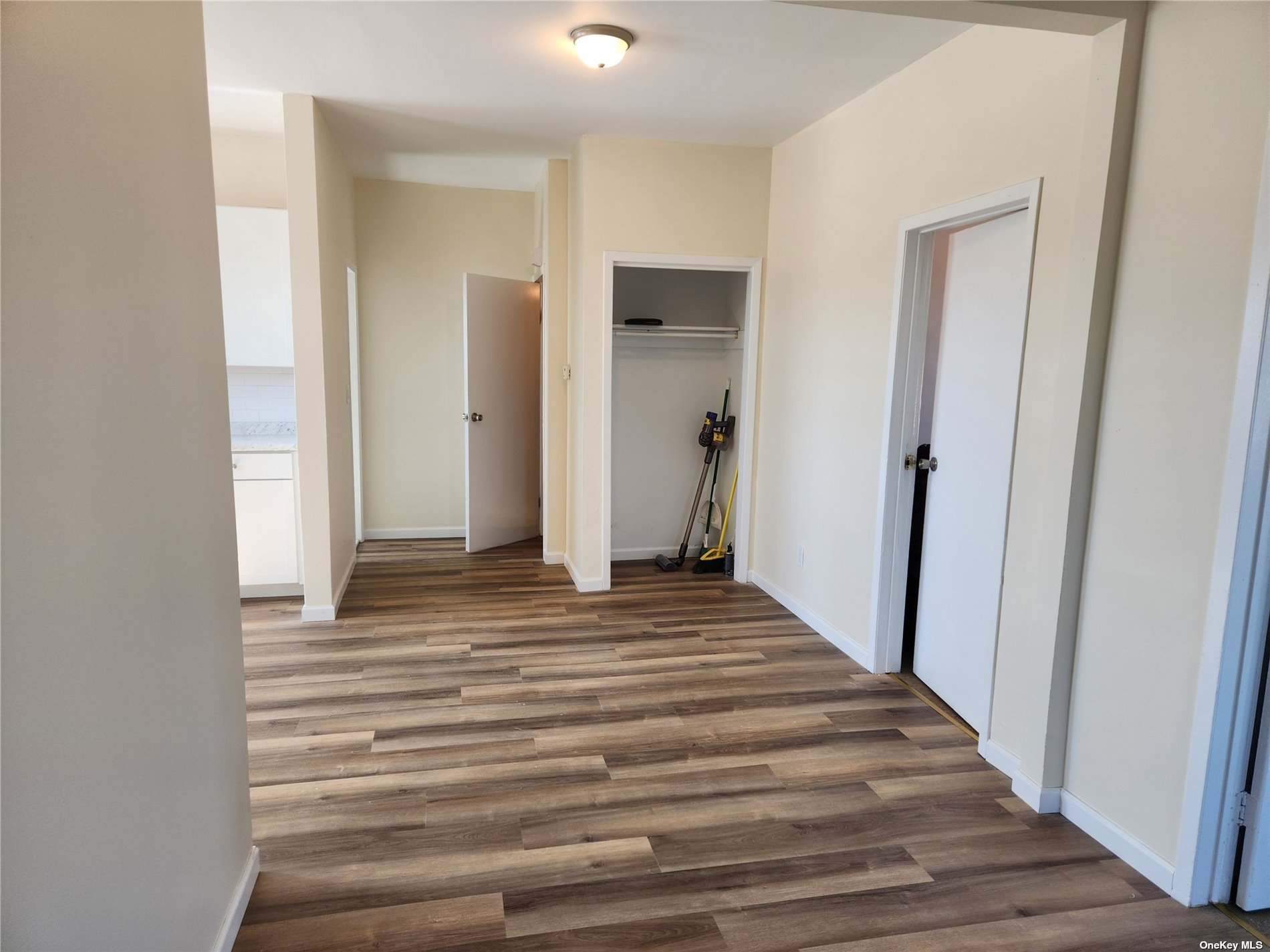 a view of a closet and wooden floor