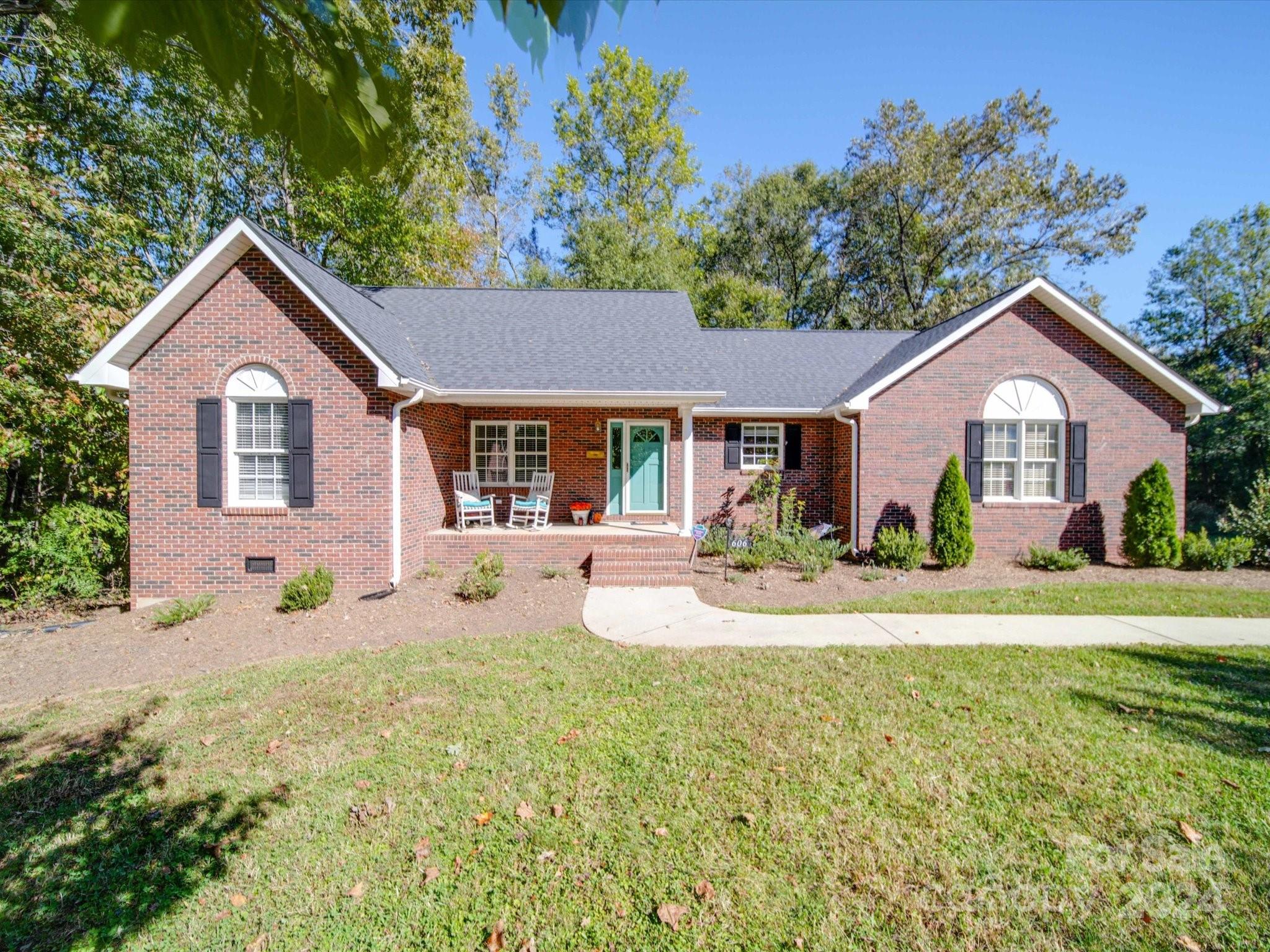 a front view of a house with a yard and porch