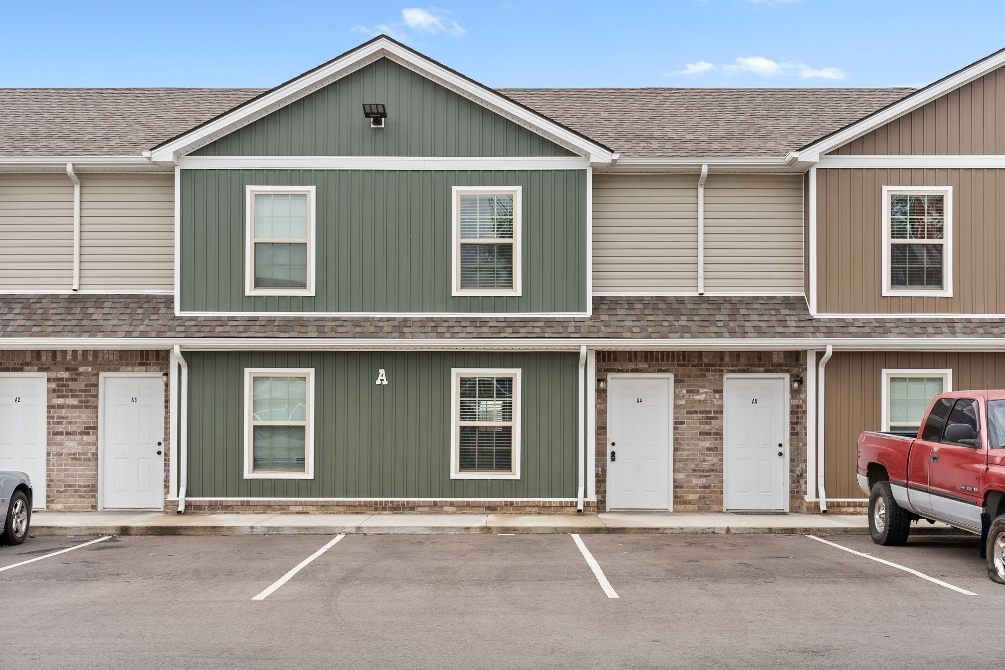 a front view of a house with a parking space