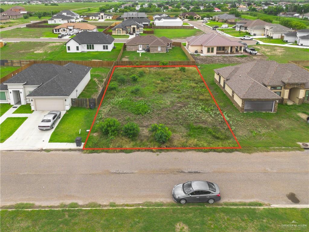 an aerial view of residential houses with outdoor space and swimming pool