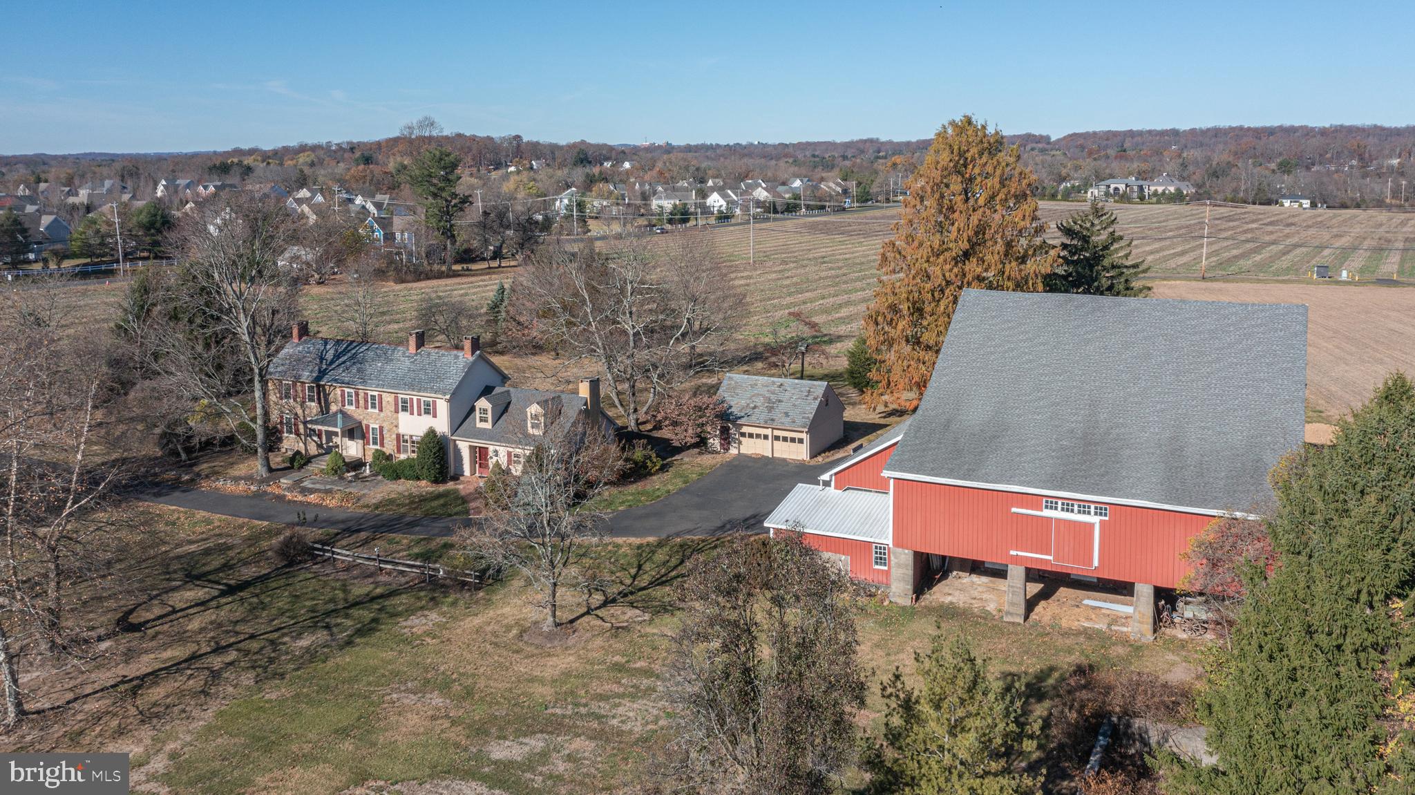 an aerial view of a house with a yard and lake view