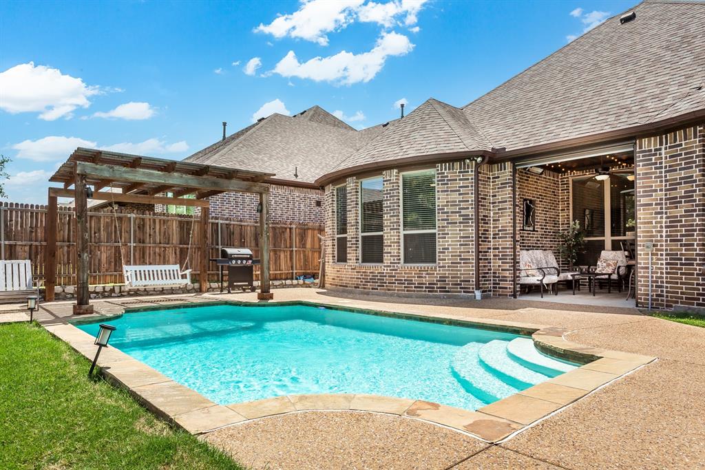 a view of a house with swimming pool and porch with furniture