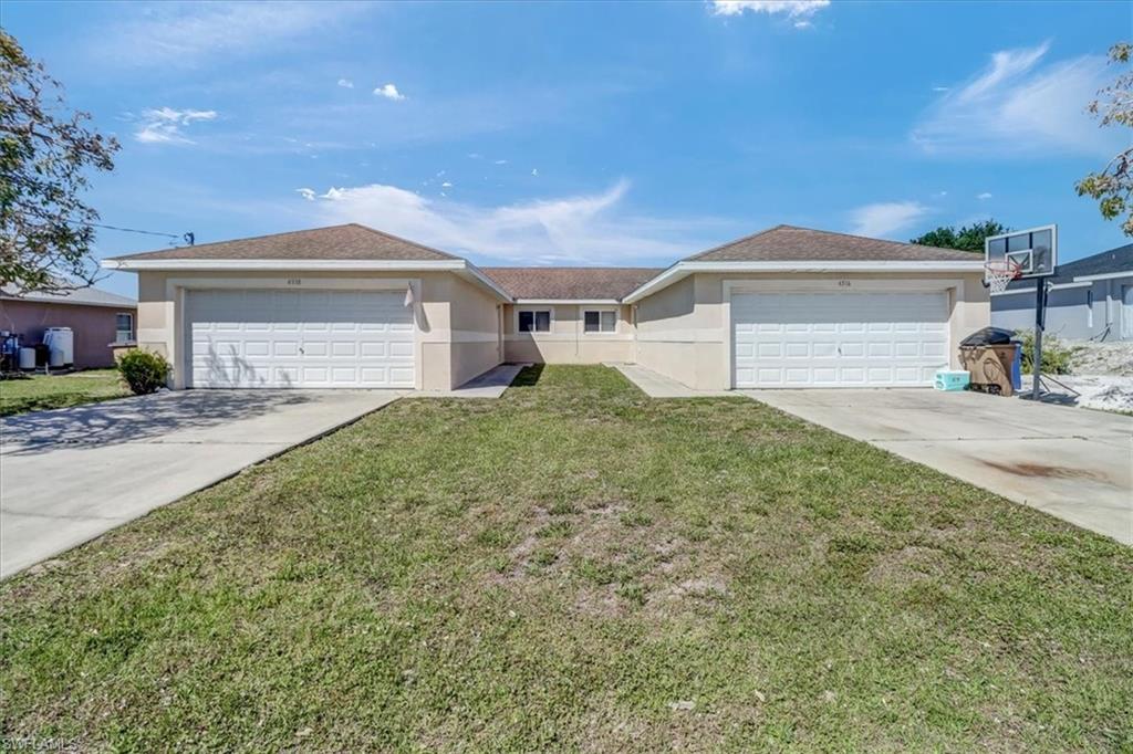 Ranch-style home featuring a garage and a front yard