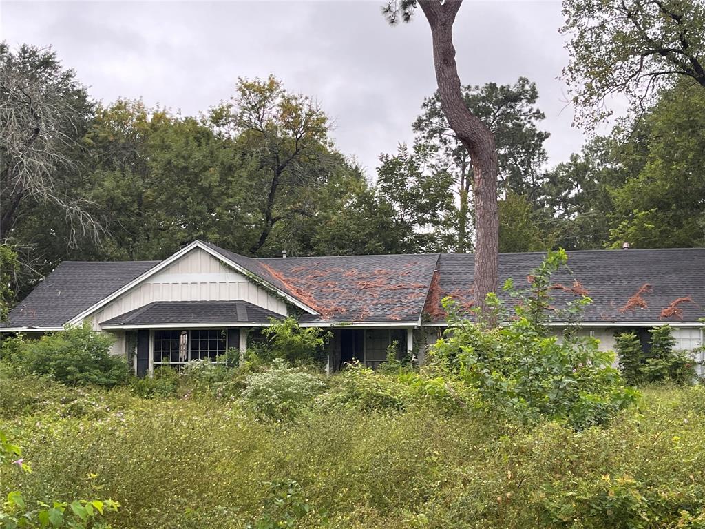 a view of a house with garden and trees