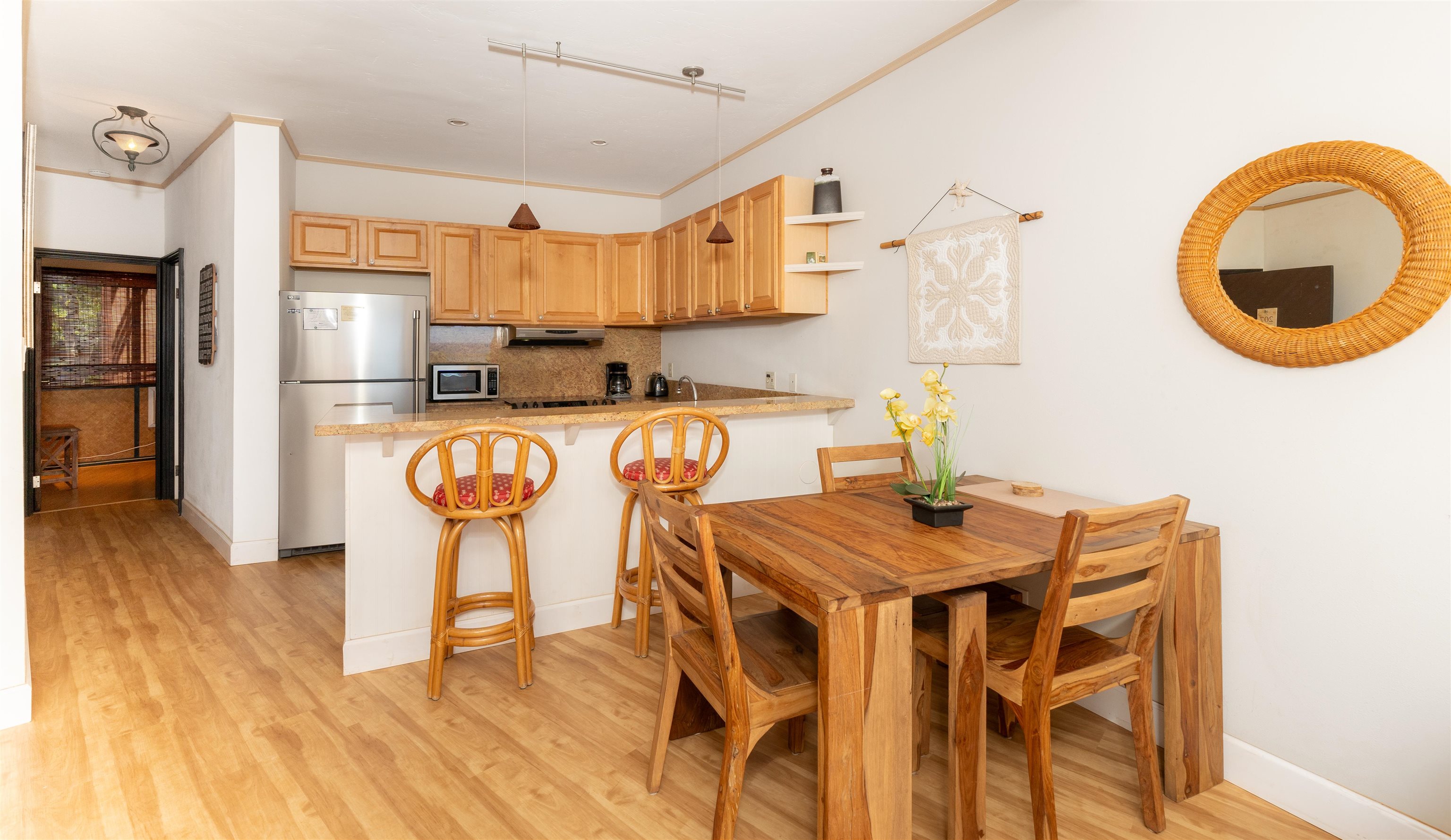 a kitchen with a table chairs refrigerator and microwave