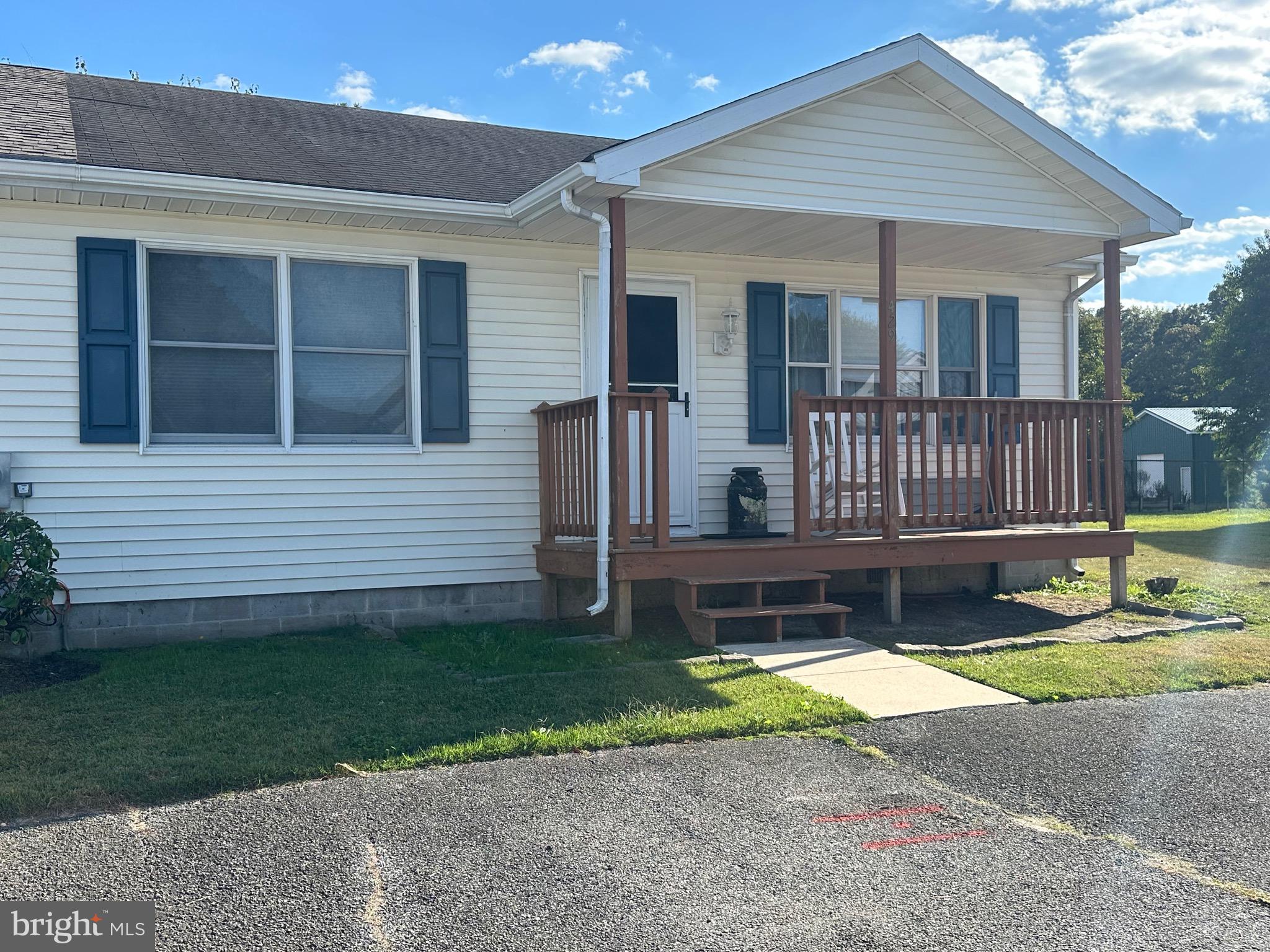 a view of a house with a yard and a garden